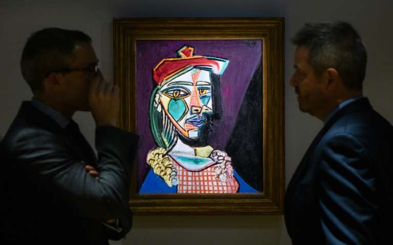 Picasso's "Femme au beret et a la robe quadrillee (Marie-Therese Walter)" displayed during an auction on February 2018. | Image source: phys.org