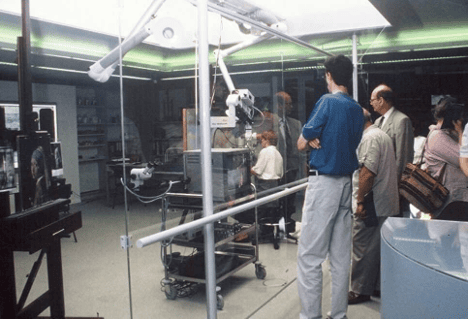 Museum visitors observing a live art conservation project