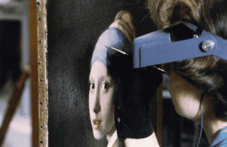 Conservator restoring Vermeer's Girl with a Pearl Earring.